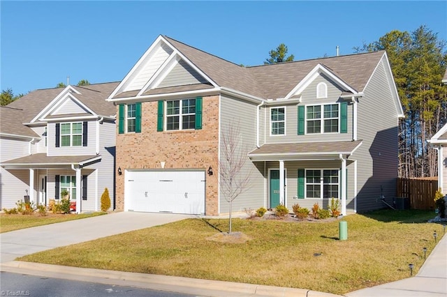 view of front of house with a porch, a front yard, and a garage