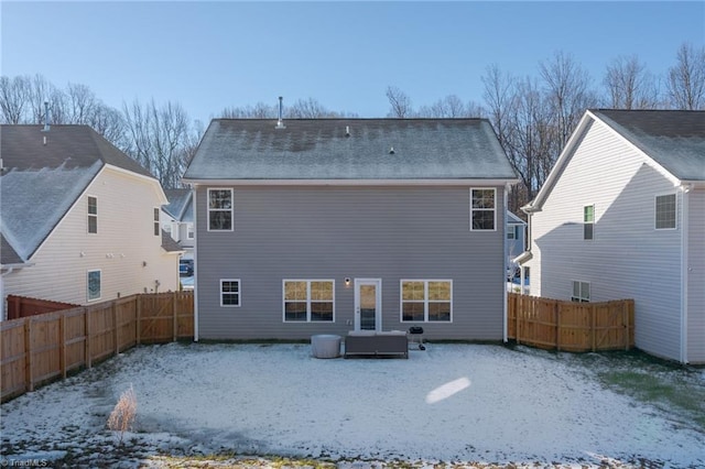 snow covered back of property with central AC unit