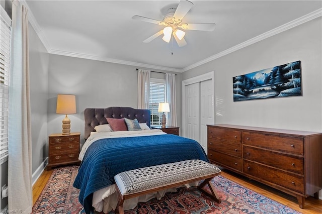 bedroom featuring ornamental molding, a closet, and light wood-type flooring