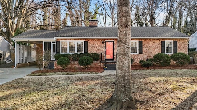 ranch-style house with a front yard and a carport