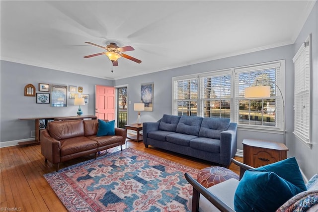 living room featuring wood-type flooring, ornamental molding, and ceiling fan