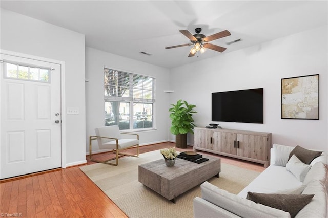 living room featuring ceiling fan and wood-type flooring