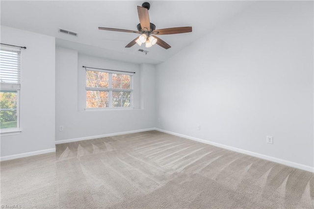 spare room featuring carpet flooring, ceiling fan, and lofted ceiling