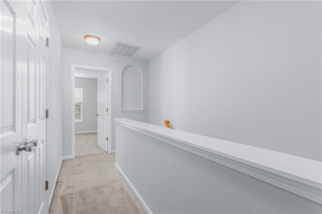 hallway with light colored carpet