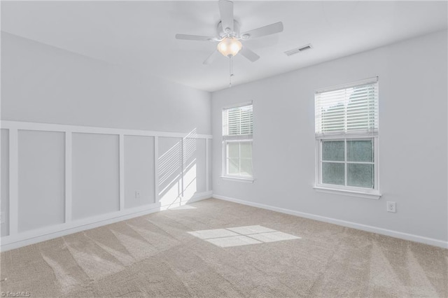 carpeted empty room featuring ceiling fan