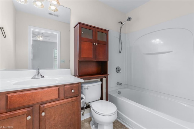 full bathroom featuring ceiling fan, vanity, bathtub / shower combination, and toilet