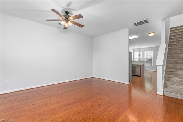 unfurnished living room with ceiling fan and wood-type flooring