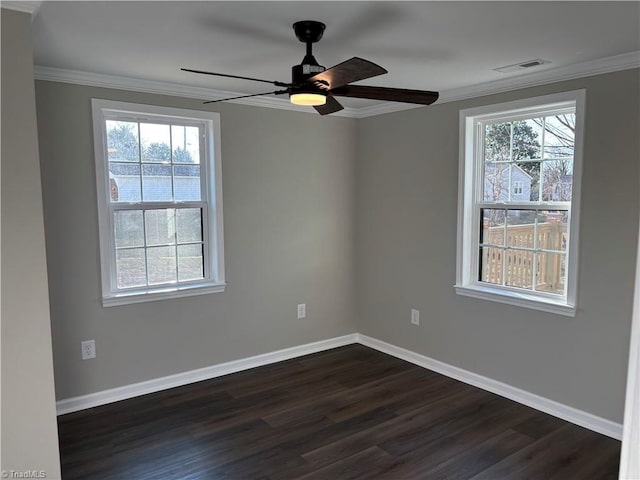 empty room featuring crown molding, dark wood-type flooring, and ceiling fan