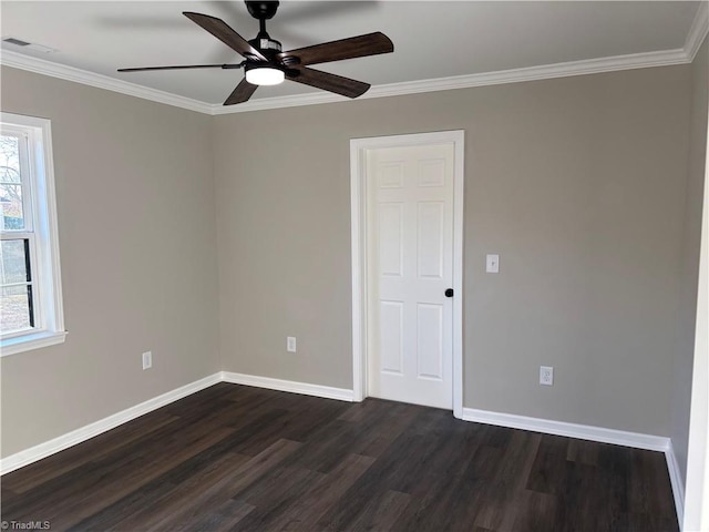 spare room featuring ornamental molding, dark wood-type flooring, and ceiling fan