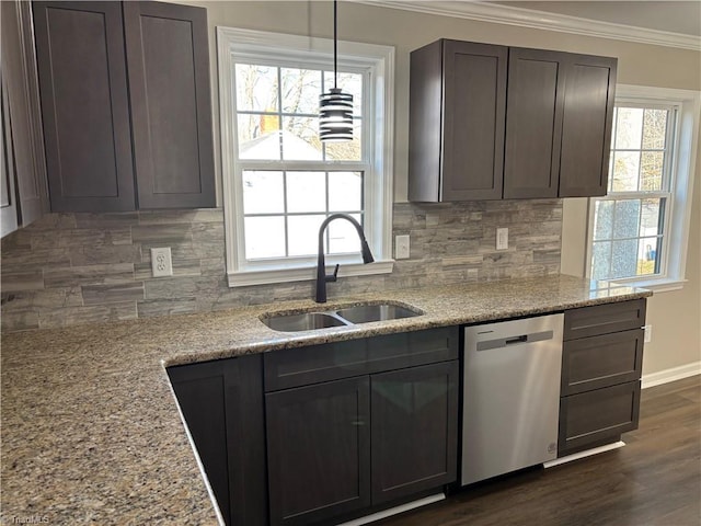 kitchen with ornamental molding, dishwasher, sink, and light stone countertops