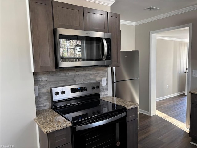 kitchen featuring stainless steel appliances, dark brown cabinetry, light stone countertops, ornamental molding, and dark hardwood / wood-style flooring