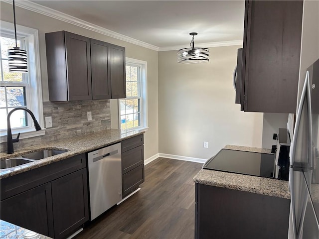 kitchen featuring decorative light fixtures, sink, backsplash, ornamental molding, and stainless steel appliances