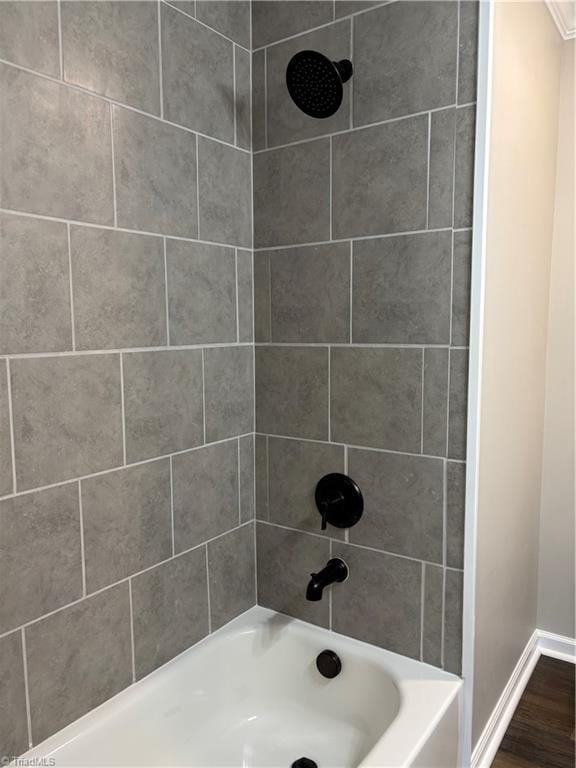 bathroom featuring hardwood / wood-style floors and tiled shower / bath