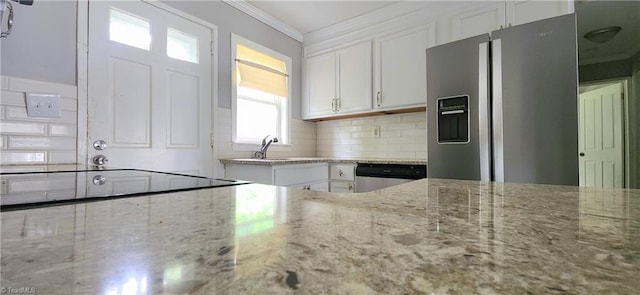 kitchen featuring white cabinetry, light stone countertops, and stainless steel appliances