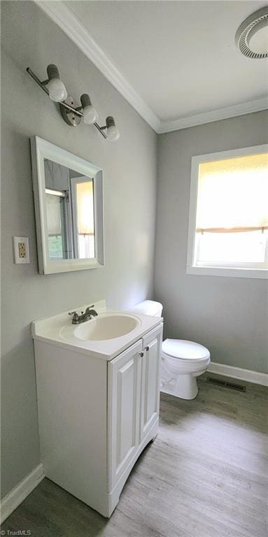 bathroom featuring crown molding, wood-type flooring, toilet, and vanity