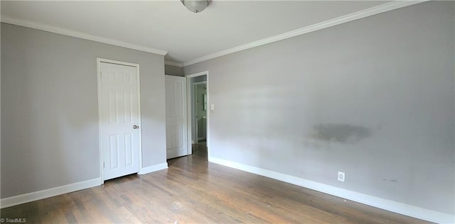 unfurnished bedroom with ornamental molding and hardwood / wood-style floors