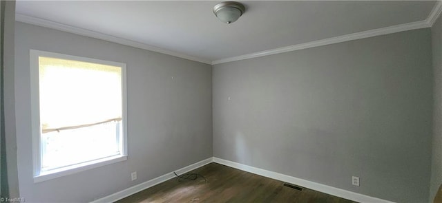 unfurnished room featuring crown molding and dark wood-type flooring