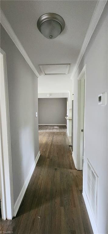 corridor with dark wood-type flooring and ornamental molding