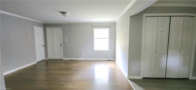 interior space featuring crown molding and dark hardwood / wood-style flooring