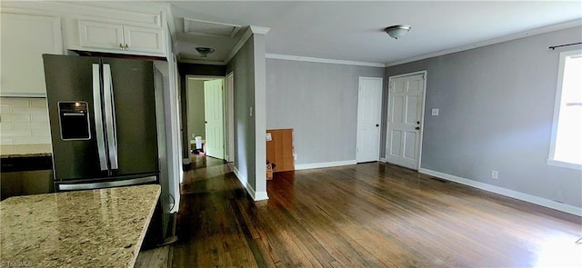 kitchen featuring refrigerator with ice dispenser, dark hardwood / wood-style flooring, white cabinets, ornamental molding, and light stone counters