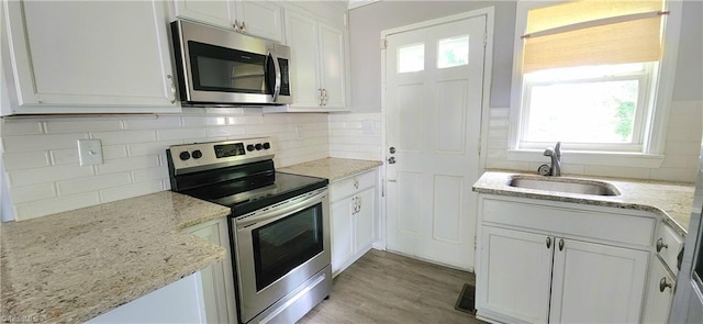 kitchen with white cabinetry, appliances with stainless steel finishes, and sink