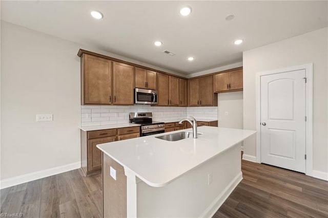 5757 Siler St, Trinity, NC 27370 - kitchen featuring visible vents, dark wood-type flooring, brown cabinets, a sink, and appliances with stainless steel finishes