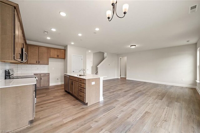5757 Siler St, Trinity, NC 27370 - kitchen featuring visible vents, open floor plan, a sink, light wood finished floors, and appliances with stainless steel finishes
