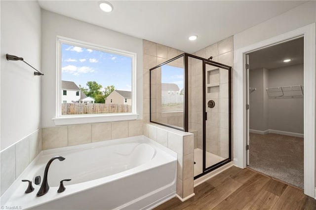 5757 Siler St, Trinity, NC 27370 - full bath featuring a shower stall, a walk in closet, a garden tub, and wood finished floors