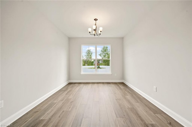 5757 Siler St, Trinity, NC 27370 - unfurnished room featuring baseboards, wood finished floors, and a notable chandelier