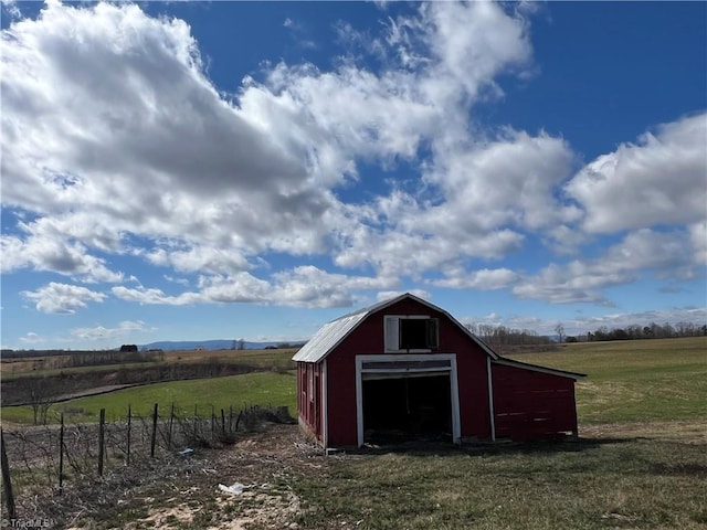 view of outdoor structure with an outbuilding and a rural view