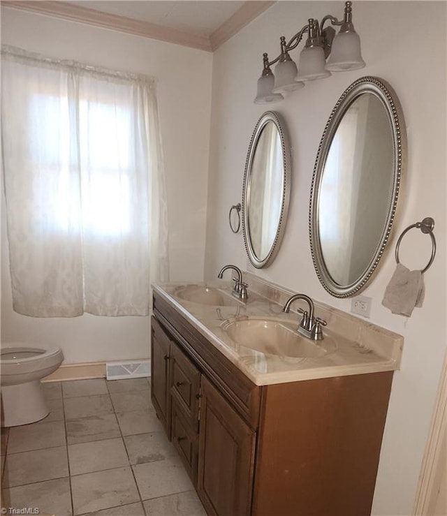 bathroom featuring crown molding, vanity, and toilet