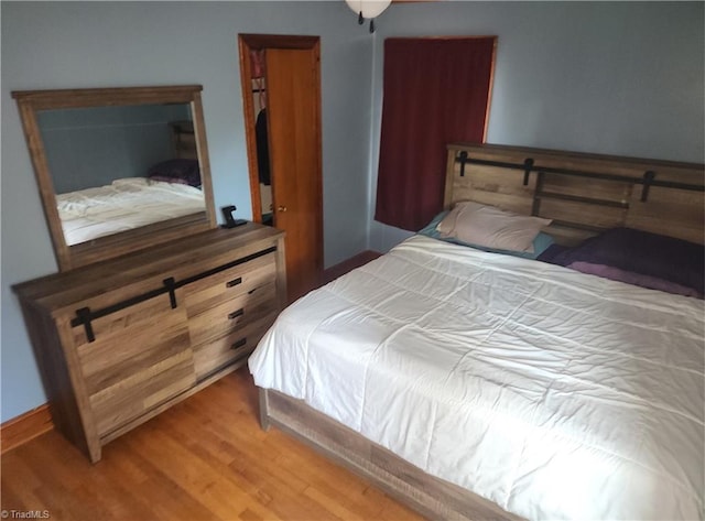 bedroom with hardwood / wood-style floors