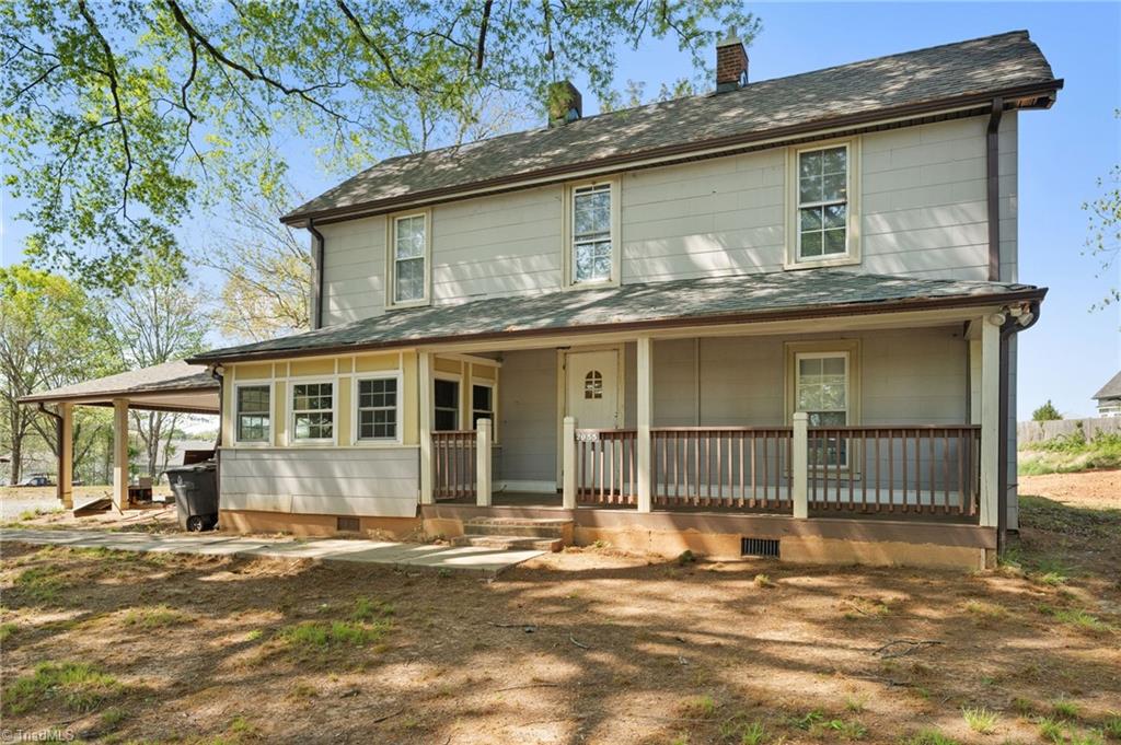 2055 Darwick Rd, Winston-Salem, NC 27127 - view of front facade with crawl space, a chimney, and covered porch