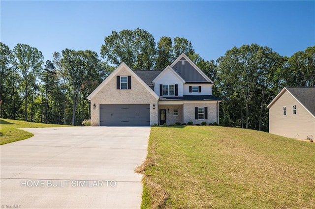 6963 Orchard Path Dr, Clemmons, NC 27012 - view of front of home with driveway, a garage, a front lawn, and brick siding