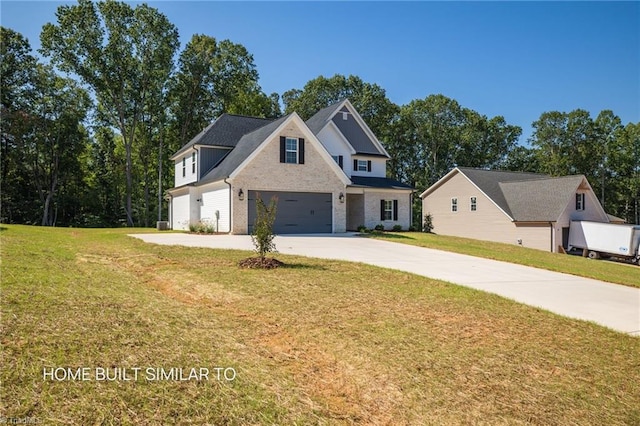 6963 Orchard Path Dr, Clemmons, NC 27012 - view of front of property with driveway, an attached garage, a front yard, and brick siding