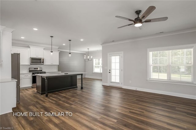 6963 Orchard Path Dr, Clemmons, NC 27012 - kitchen featuring appliances with stainless steel finishes, ornamental molding, a kitchen breakfast bar, ceiling fan, and baseboards
