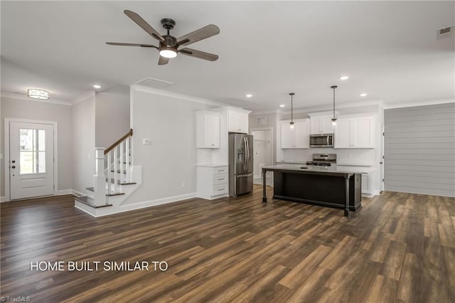 6963 Orchard Path Dr, Clemmons, NC 27012 - kitchen featuring stainless steel appliances, ornamental molding, recessed lighting, a kitchen breakfast bar, and dark wood-style floors