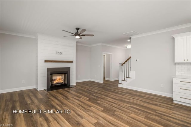 6963 Orchard Path Dr, Clemmons, NC 27012 - unfurnished living room with a ceiling fan, dark wood finished floors, crown molding, baseboards, and stairway
