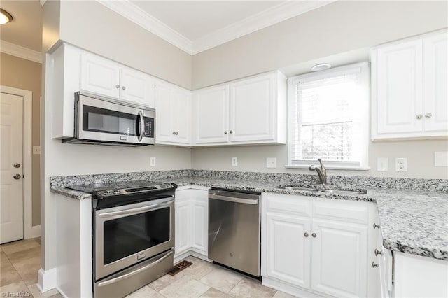 kitchen featuring a sink, white cabinets, ornamental molding, and stainless steel appliances