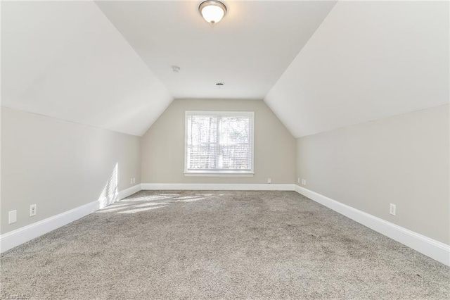 bonus room with vaulted ceiling, baseboards, and carpet floors