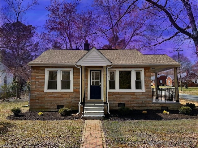 bungalow-style house with crawl space, stone siding, a chimney, and roof with shingles