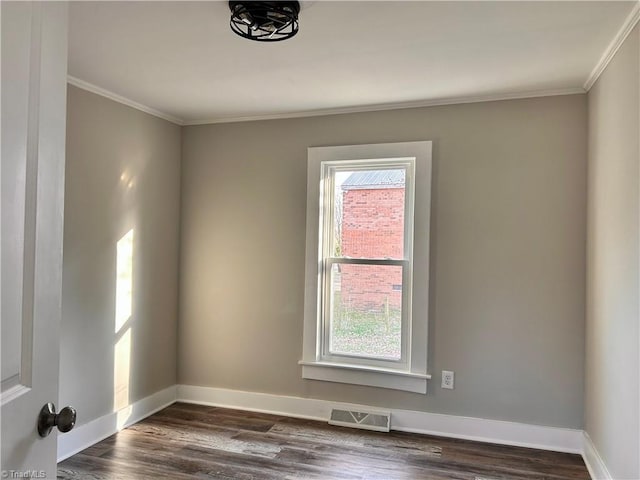 unfurnished room with visible vents, crown molding, dark wood-type flooring, and baseboards