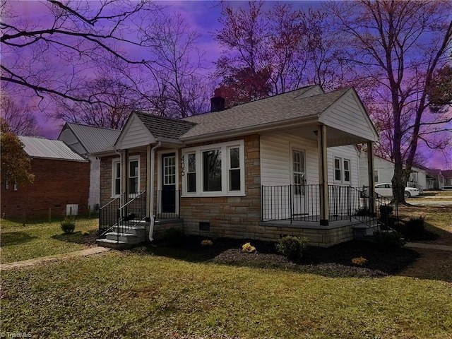 view of front of home with crawl space, stone siding, a chimney, and a front yard