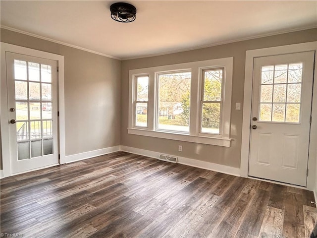 doorway featuring baseboards, dark wood-style floors, visible vents, and ornamental molding