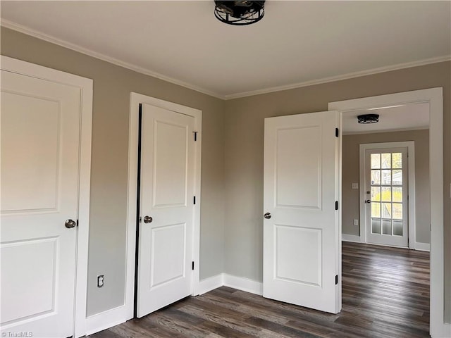 unfurnished bedroom with baseboards, dark wood-style flooring, and ornamental molding