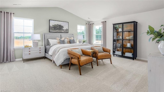 bedroom featuring light carpet and vaulted ceiling