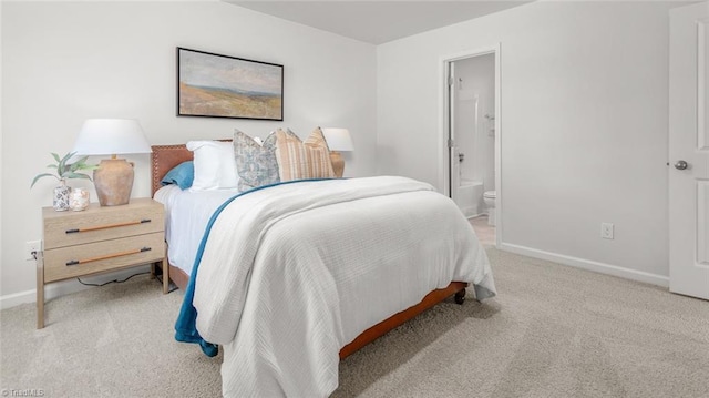 carpeted bedroom featuring ensuite bathroom