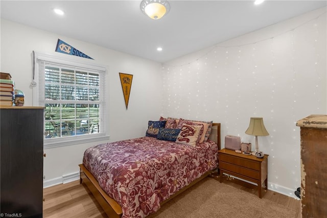 bedroom featuring baseboards, recessed lighting, and wood finished floors