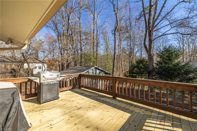 wooden deck featuring area for grilling