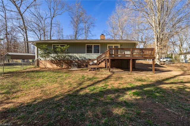back of house with fence, a deck, a chimney, a yard, and stairway